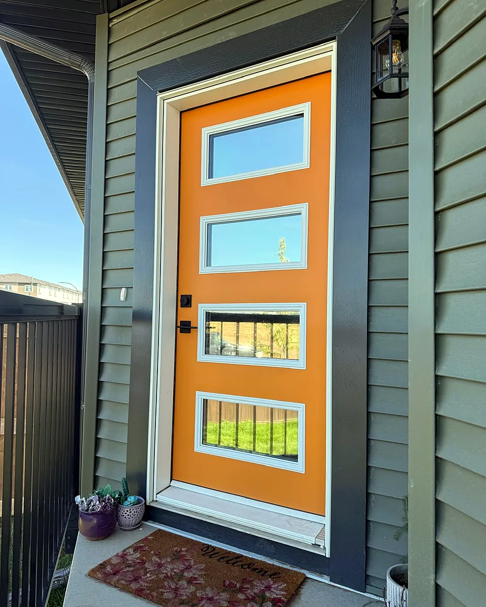 Orange front door with four tinted glass inserts